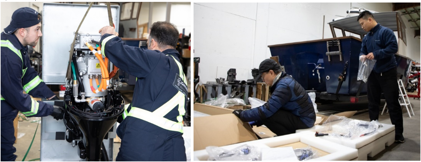 Two people wearing coveralls work on an electric boat engine.