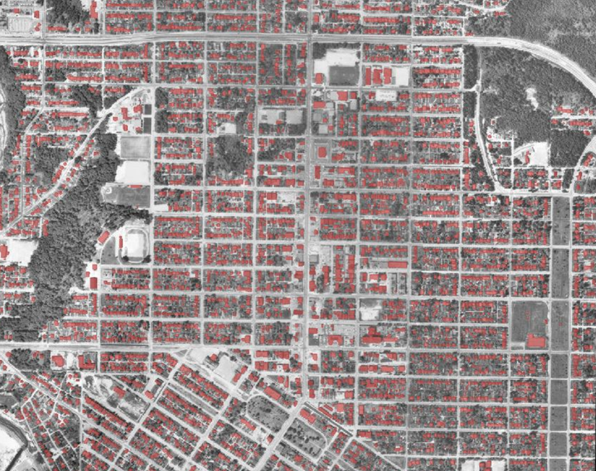 Historical air photo with buildings identified in red