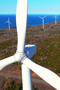 Aerial view of wind turbines near the ocean.