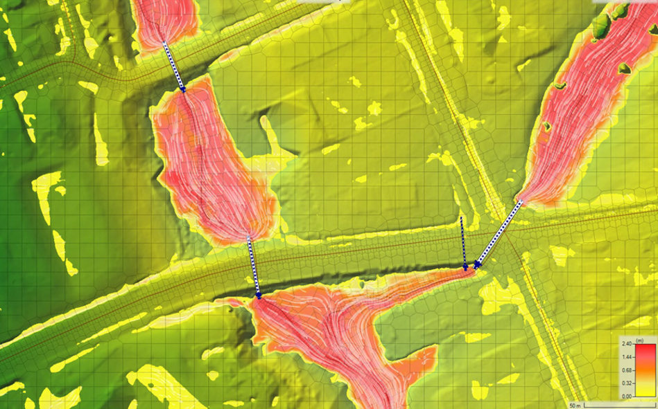 Terrain model showing culverts, embankments, and flow paths across a road crossing and valley.