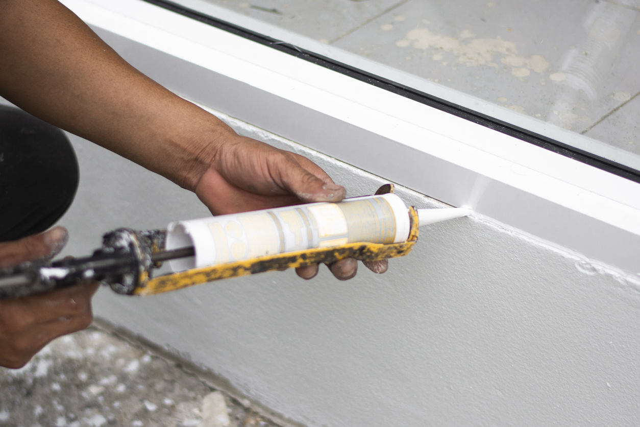 Caulking between window and baseboard.