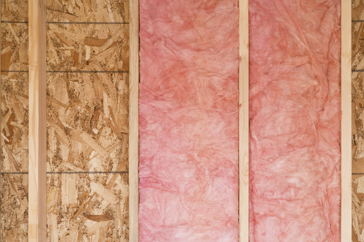 Close-up of strips of insulation in a wall of a basement. 