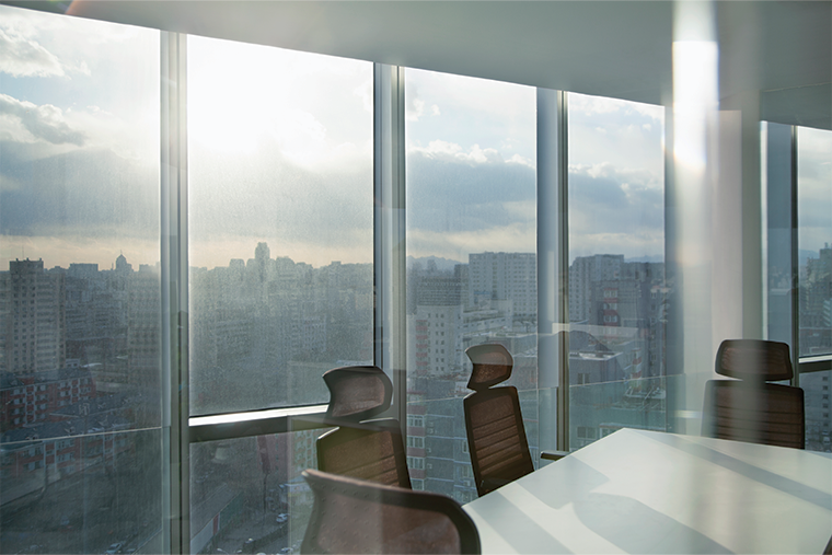 Empty boardroom with large windows.