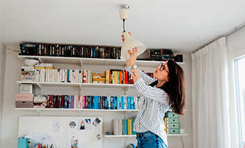 Woman changes light bulb