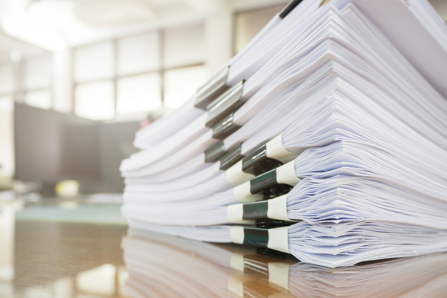 a stack of paper on a desk