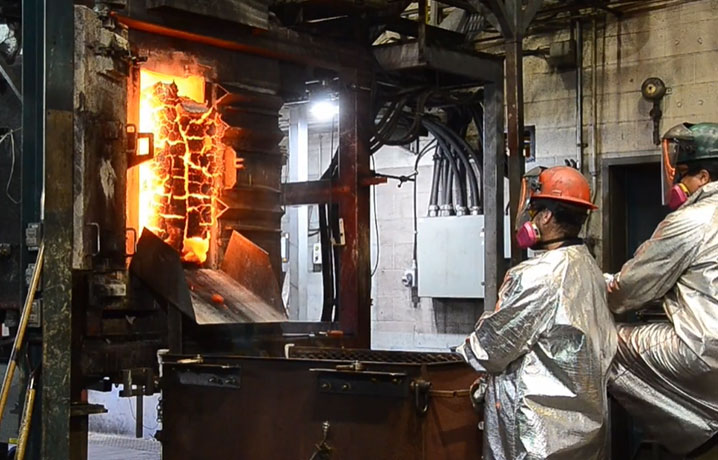 Red-hot coke being pushed out of a pilot-scale coke oven.