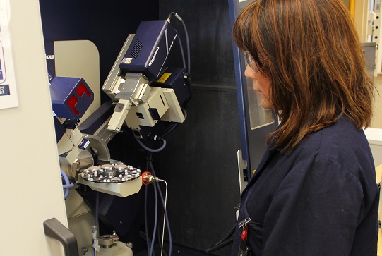 A scientist uses a powder x-ray diffraction (PXRD) spectrometer to determine and quantify phases present in a variety of energy R&D related samples