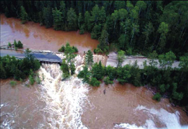 FIGURE 19: photograph of flooding and damage to a roadway in northwestern Ontario resulting from a very intense thunderstorm in June 2002