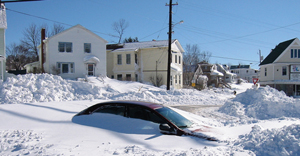 Photo of car covered in snow drifts
