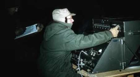Technician operating the Geodimeter 2 outside in the dark