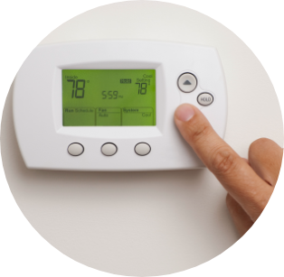 Image of smart thermostat with finger pressing on the arrow down button to lower temperature.