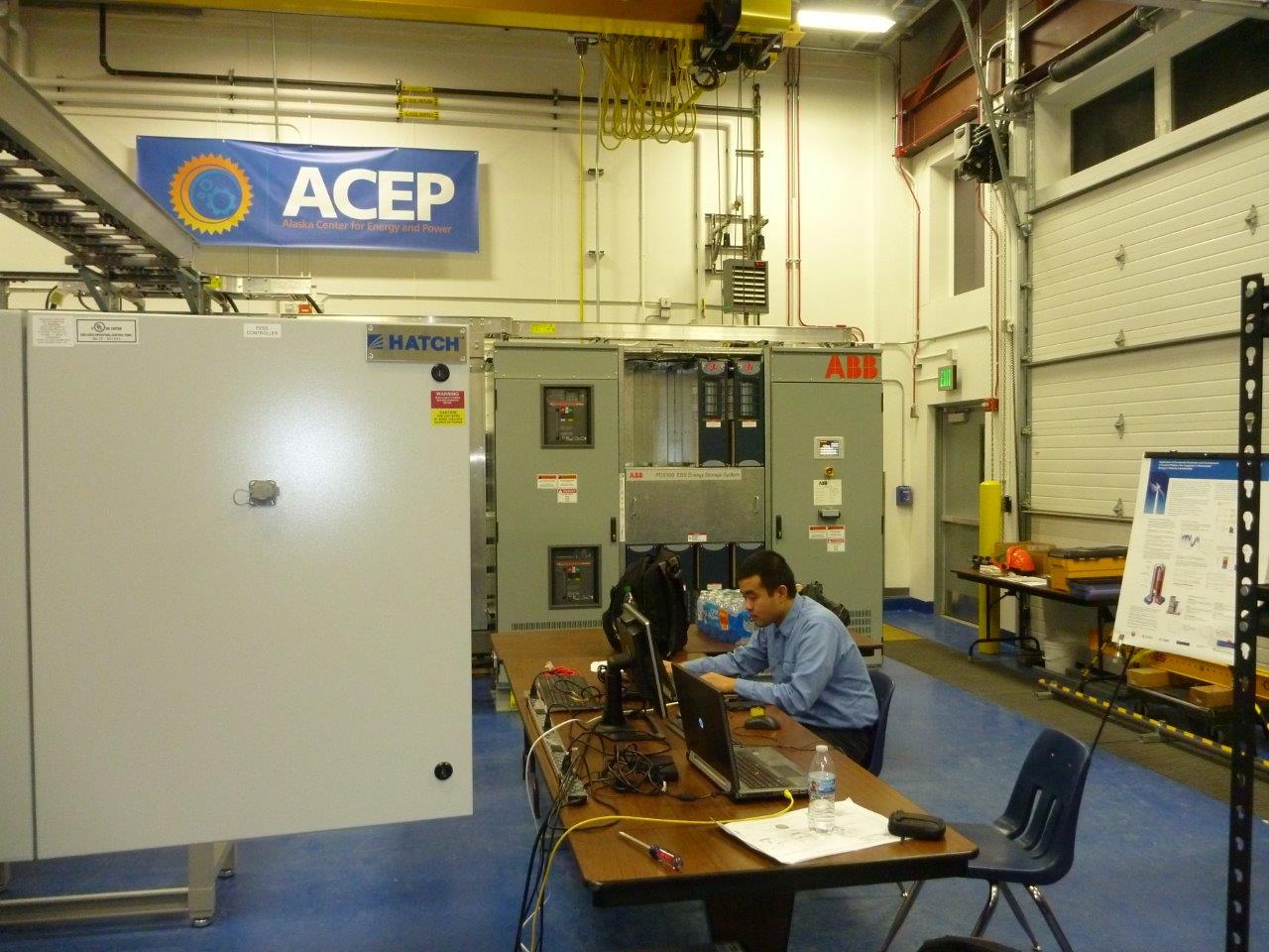 Hatch engineer working at a computer terminal connected to Hatch microgrid controller within a lab facility in Alaska