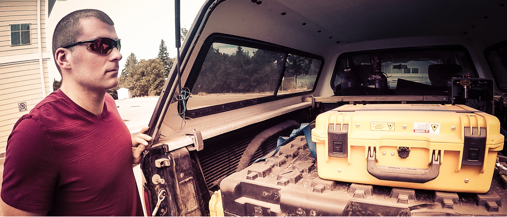 Flux Lab researcher, James Williams, with research truck ready for another day of fugitive emissions mapping. The research truck pictured is Toyota Tacoma with a cap that stores the detection equipment while data is collected.