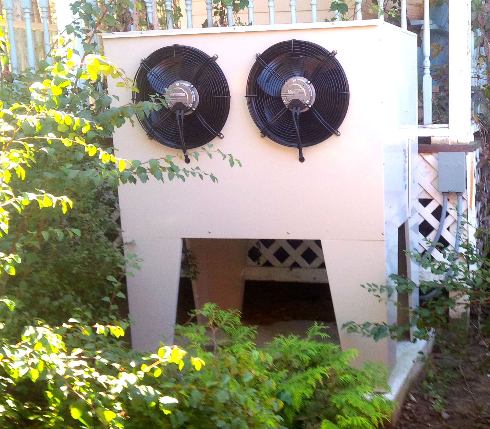 image of an outdoor unit of a cold climate heat pump (CCHP) system installed in the side yard of an existing home near Ottawa, Ontario