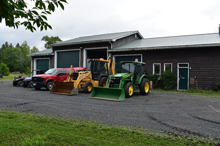 Picture of vehicles parked outside of the Acadia Research Forest headquarters near Fredericton, New Brunswick.