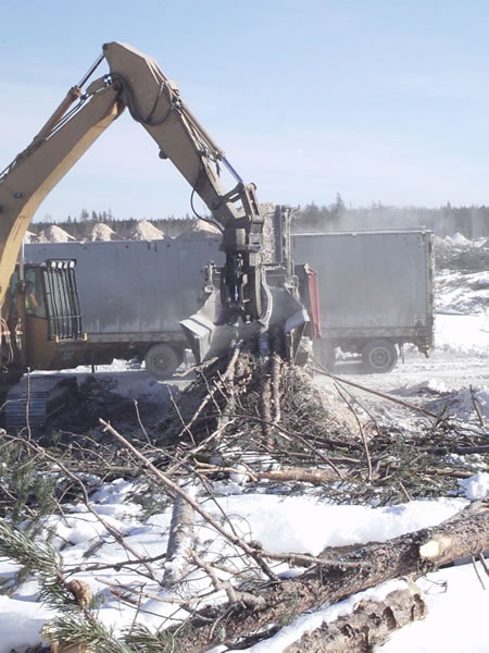 Grinding harvesting slash into wood chips.