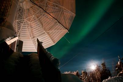 A dish antenna with the aurora behind it. (Copyright 2012 Terry Halifax Photography)
