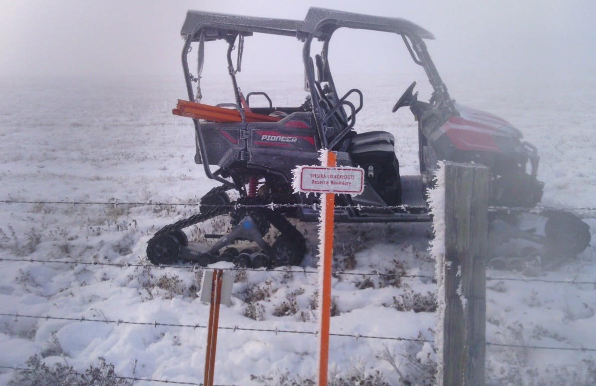 Snowmobile near a fence