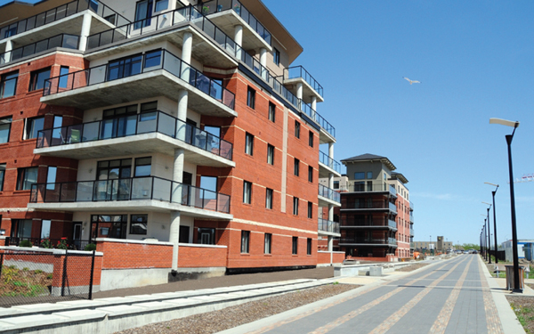 This is a photo of multi-unit residential buildings and the cycling path in Centre in the Park, Strathcona County, Alberta.