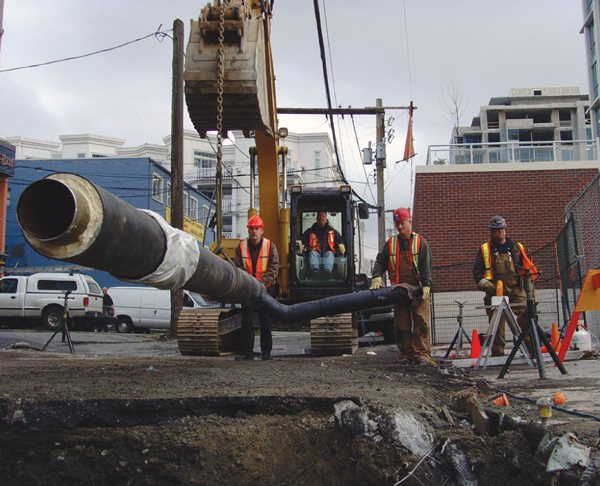 This is a photo of construction workers laying district energy piping.