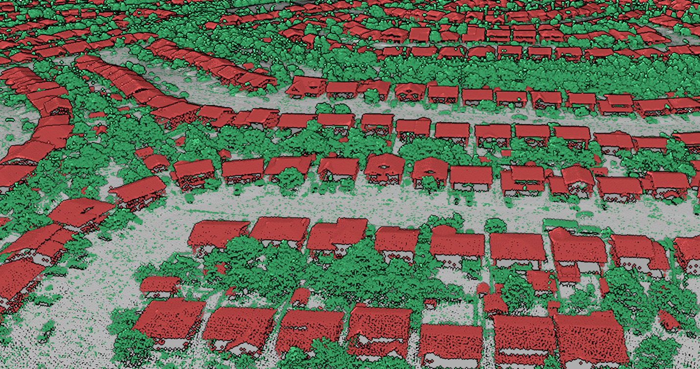 A 3D view of LiDAR point clouds from above a neighbourhood of houses and trees. Points corresponding to buildings, trees and the ground were colorized as red, green and gray, respectively. 