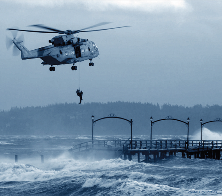 A man is airlifted from White Rock Pier in British Columbia by a helicopter rescue team during a severe windstorm that caused the mid-section of the pier to collapse.